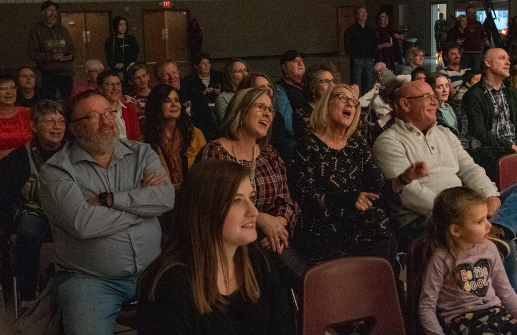 Several members of the 2022 audience of MCT's Holly Jolly Holiday Show laughing.